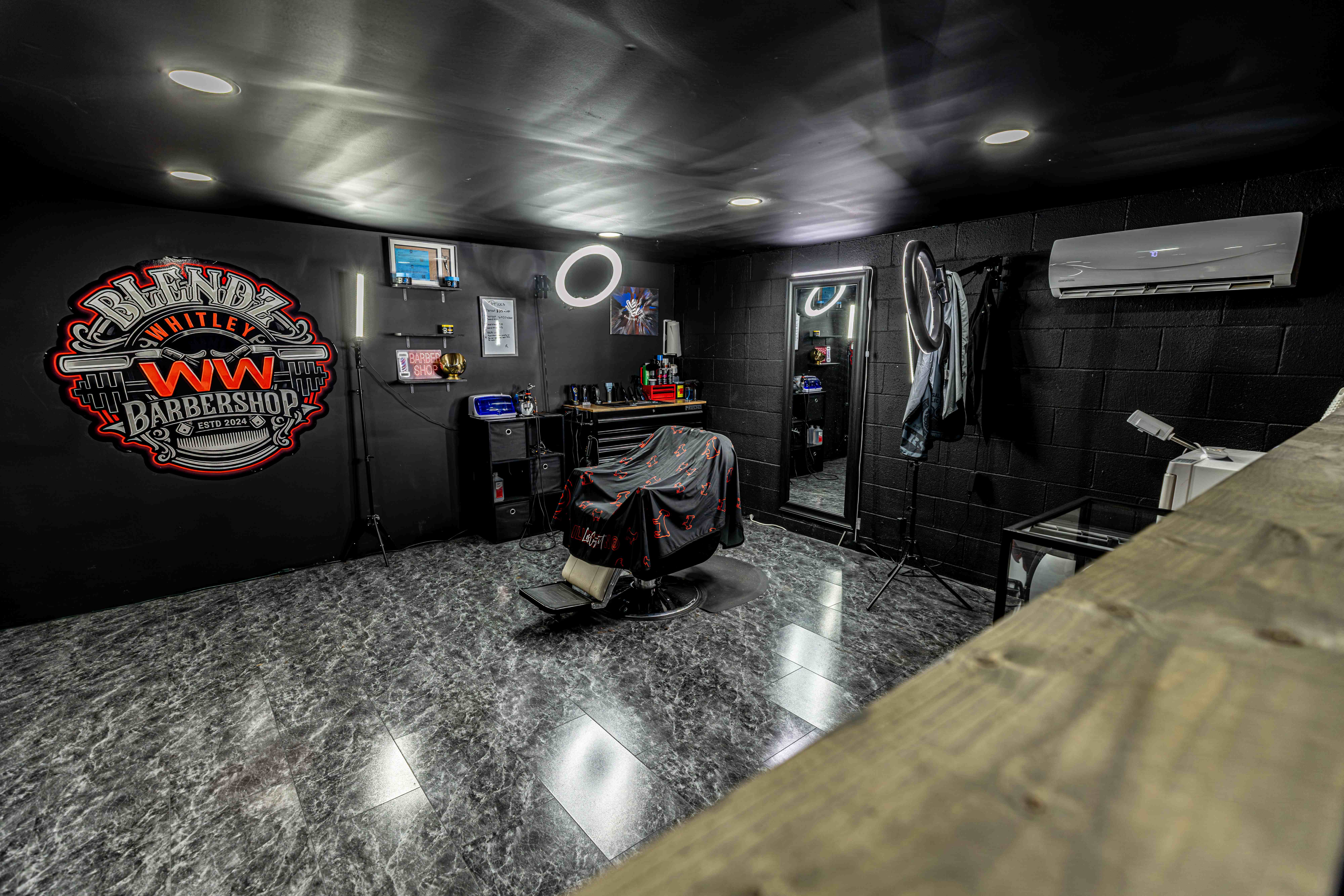 The Blendz WW Barbershop inside Whitley Weights with barber chair, mirror, and logo wall