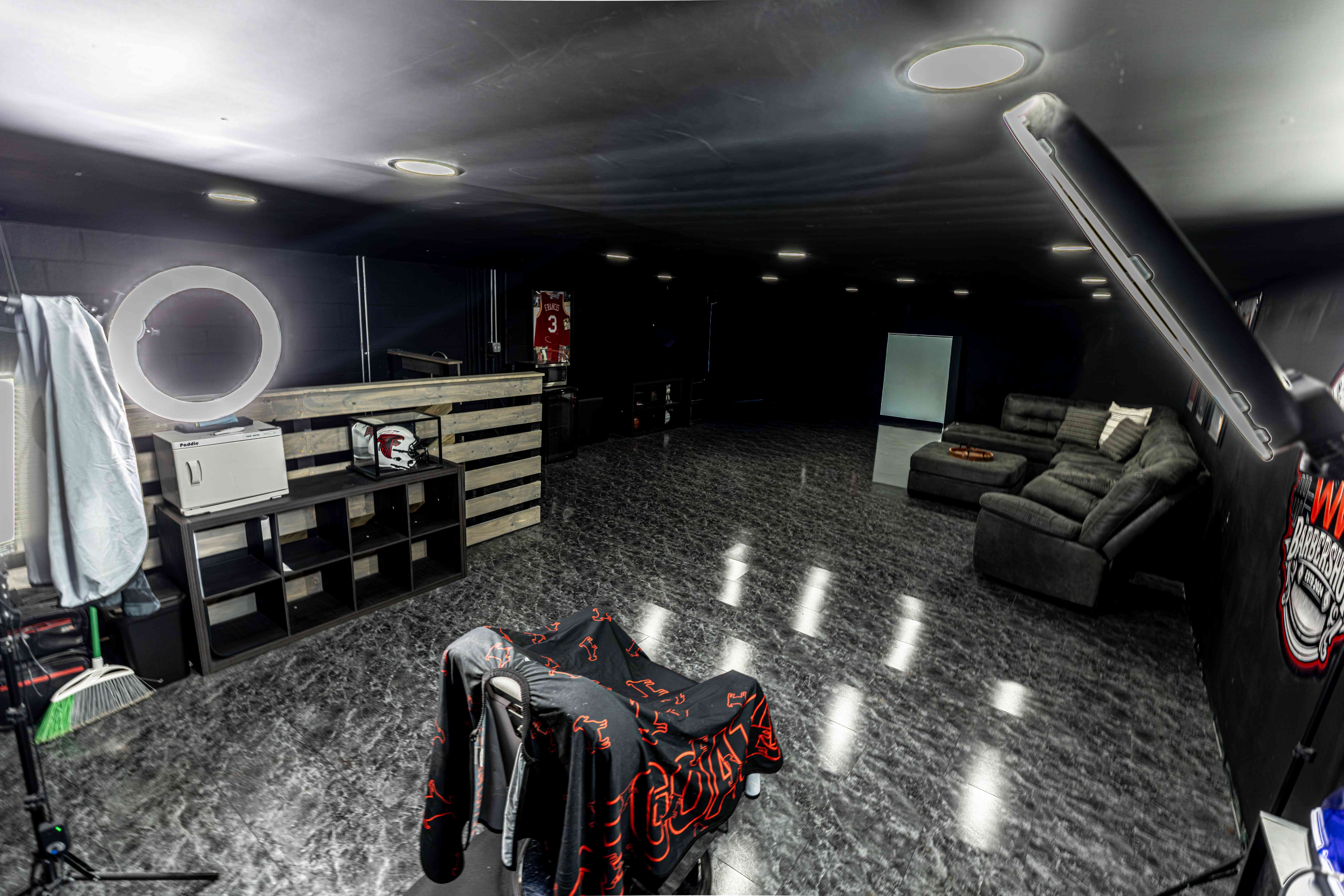 The WW Barbershop showing the pallet-wood front desk and lounge seating