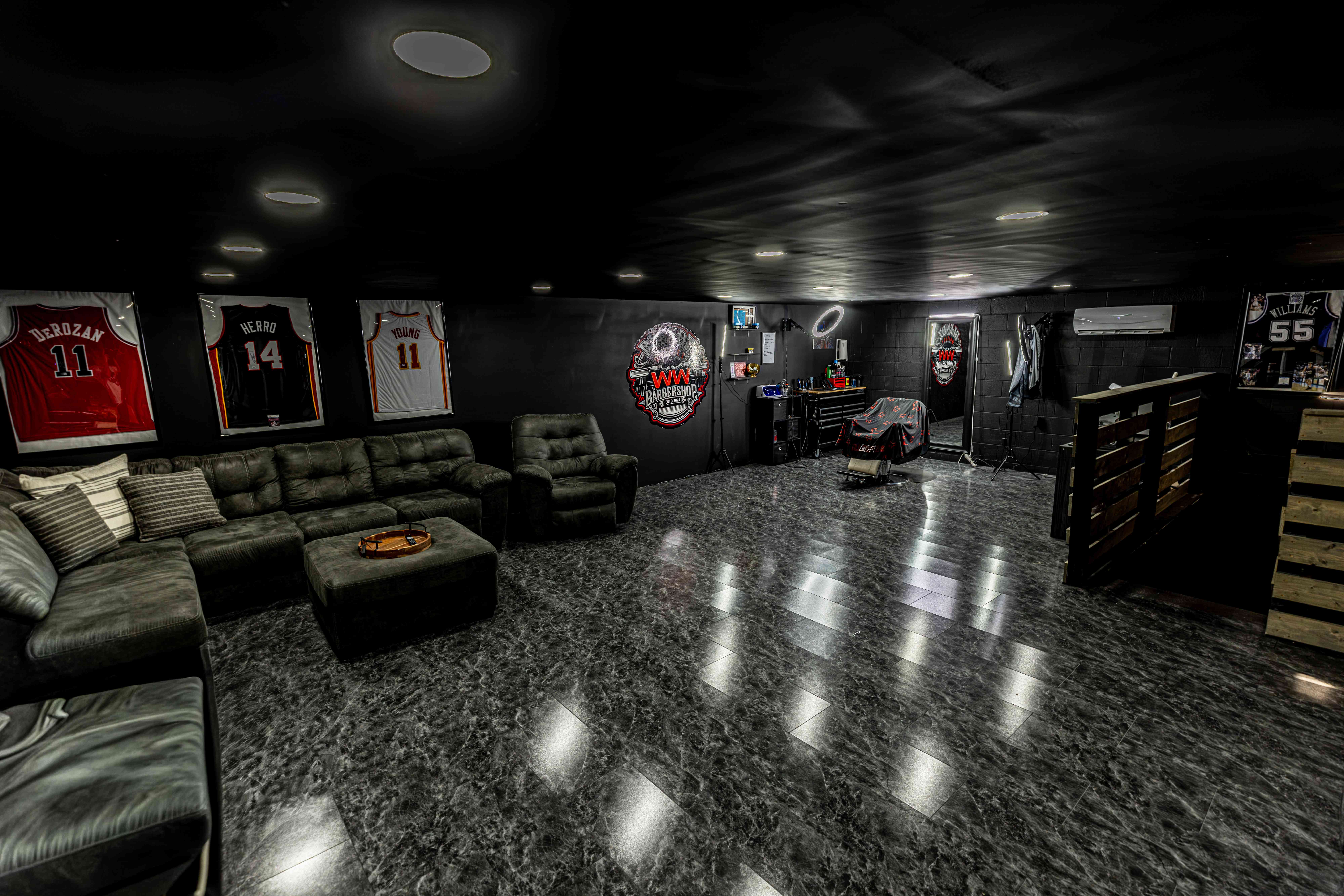 The WW Barbershop lounge inside Whitley Weights with leather seating and framed jerseys