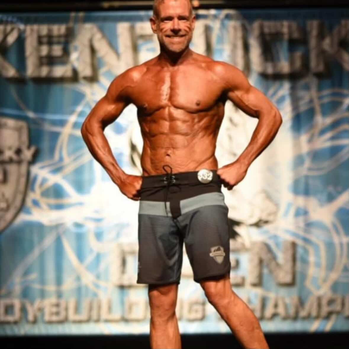 Male physique competitor on the Kentucky championship stage