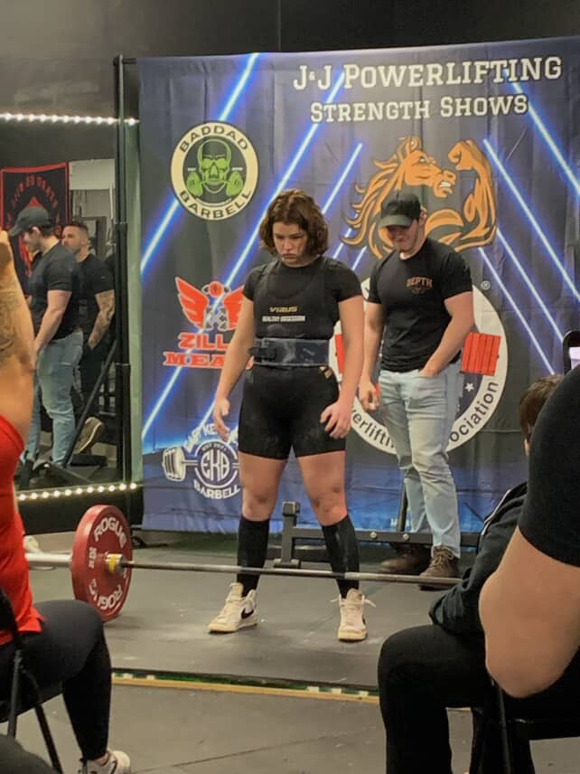 Female powerlifter setting up a deadlift at a J&J Powerlifting meet