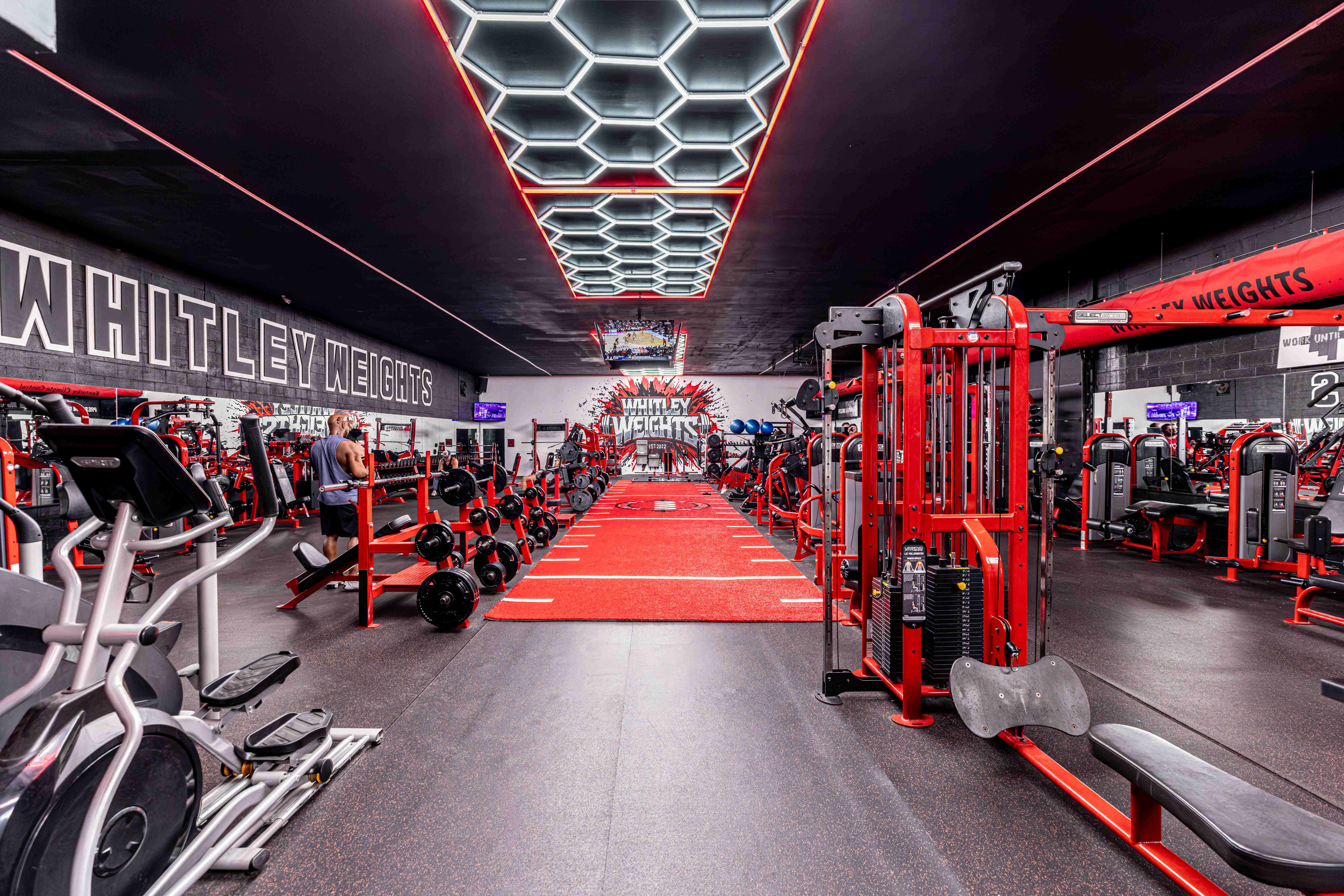 The Whitley Weights training floor with its red turf runway and hexagon lighting